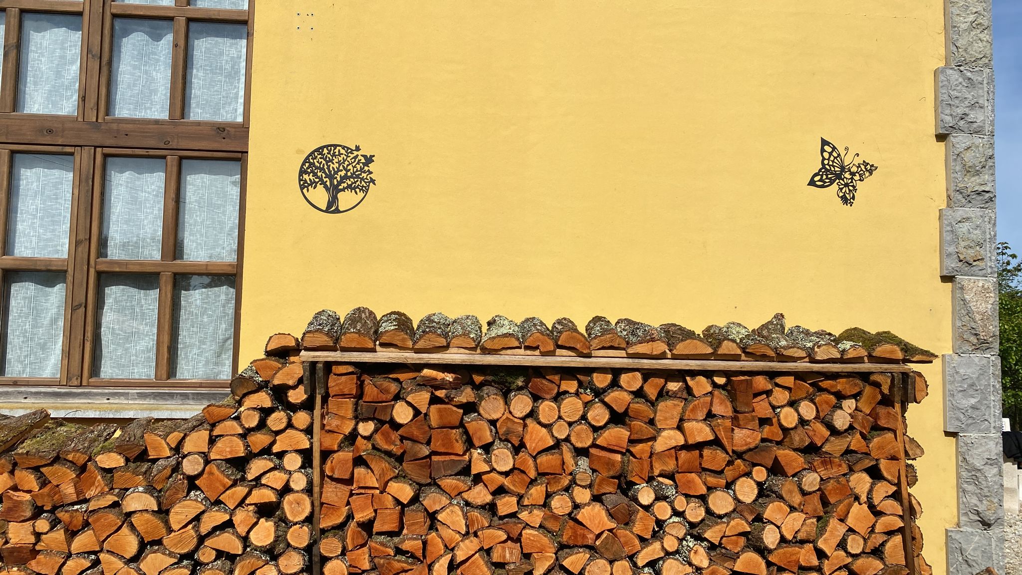 Detalle exterior de la casa de la leña apilada